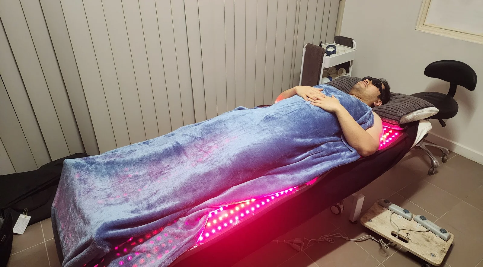Client lying on a red light therapy mat during a remedial massage session at PCRMT in Point Cook